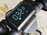a digital clock on the handlebar of a bike