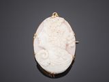 an antique carved cameo of a woman with flowers in her hair