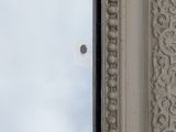 a close up of a window with a sky in the background