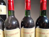 several bottles of wine are lined up in a row on a table