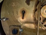 a close up of a clock with a key on it