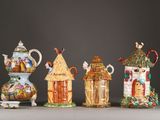 several different types of ceramic teapots are lined up on a table