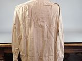beige shirt on a table with a mirror in the background