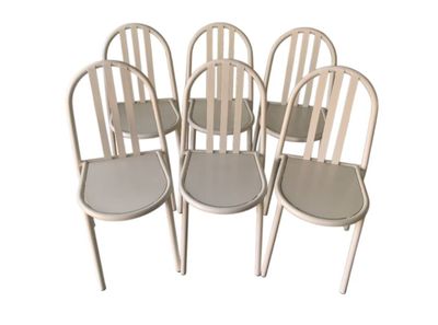 six white metal chairs sitting next to each other on a white surface