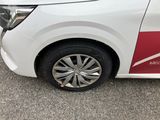 a white car with a red stripe parked in a parking lot