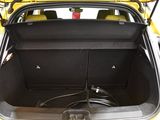 a yellow car with its trunk open and a hose in the trunk