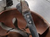 a metal bucket with a pair of spoons in it