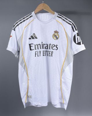 a white shirt hanging on a hanger in a room