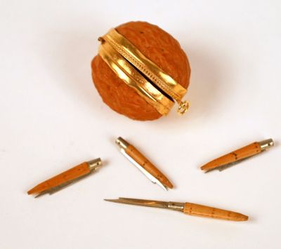 a few pens and a ball of wood on the table