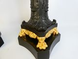 a black and gold table with a clock on top of it