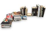 a lot of books that are stacked on top of each other