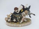 a figurine of a man and a woman on a bull