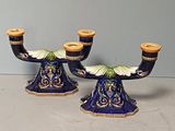 pair of blue and yellow candlesticks with gold accents