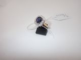une bague sertie d'une pierre bleue, posée sur une table