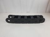 a close up of a black plastic chain on a white surface