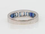 a close up of a ring with blue and white stones