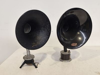 deux enceintes noires posées sur une table blanche