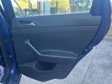 a blue car door with a black handle and the door handle is open