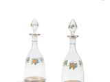 pair of glass decanters with flowers and leaves on them