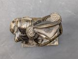 an antique bronze figurine of a woman with a hat on her head