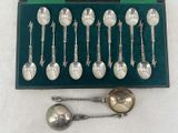 silver spoons and spoon spoons in a green box on a white surface