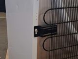 an image of a white refrigerator with a bunch of wires on it