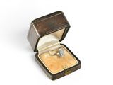 a ring in a ring box on a white surface