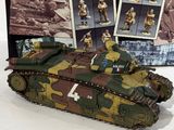 a toy tank that is on display in front of a book