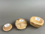 three pieces of wood sitting on top of a table