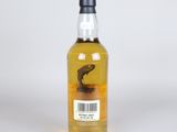 a bottle of whisky sitting on top of a white surface