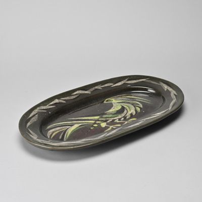 a close up of a plate with a bird on it