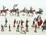 many figurines of soldiers on a white surface