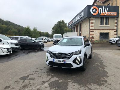 the white car is parked in front of the building in the parking lot