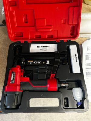 a red box with a tool in it on the floor