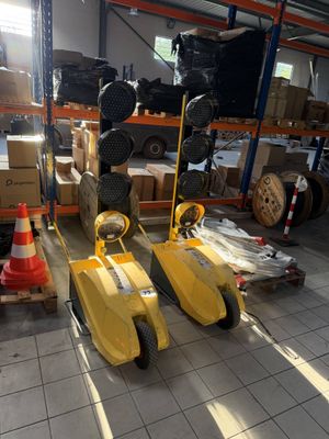 two yellow pedals that are sitting in a warehouse