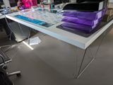 a desk with a computer, keyboard, and other office supplies on it
