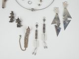 many different types of jewelry displayed on a white surface
