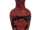 a red vase with black and blue designs on it