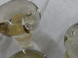 three glasses of wine sitting on a table with a white table cloth