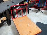 a desk with a chair and a table in the middle of the room