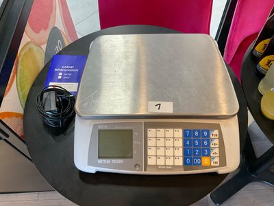 a scale that is on a table next to a chair