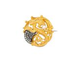a close up of a gold and diamond broochle on a white background