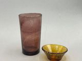 a glass and a bowl sitting on a table
