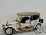 a model of an old car on a white surface