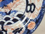 a blue and white plate with a fish design on it