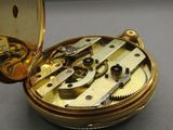 a close up of a pocket watch on a table