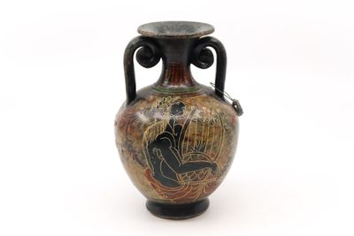 a vase with a painting on it on a white surface