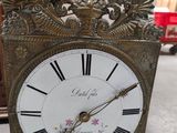 a clock that is sitting on the floor in the room