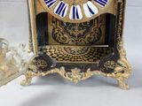 a clock that is sitting on a table next to a mirror