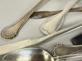 a lot of silver spoons and spoon spoons on a table